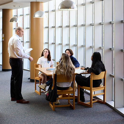 A professor talking to a group of students. Link to Life Stage Gift Planner Ages 60-70 Situations. A professor talking to a group of students. Link to Life Stage Gift Planner Ages 60-70 Situations.