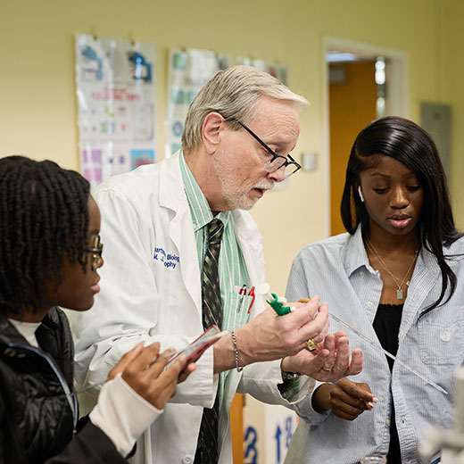 A professor in a lab with two students. Link to Life Stage Gift Planner Over Age 70 Situations. A professor in a lab with two students. Link to Life Stage Gift Planner Over Age 70 Situations.